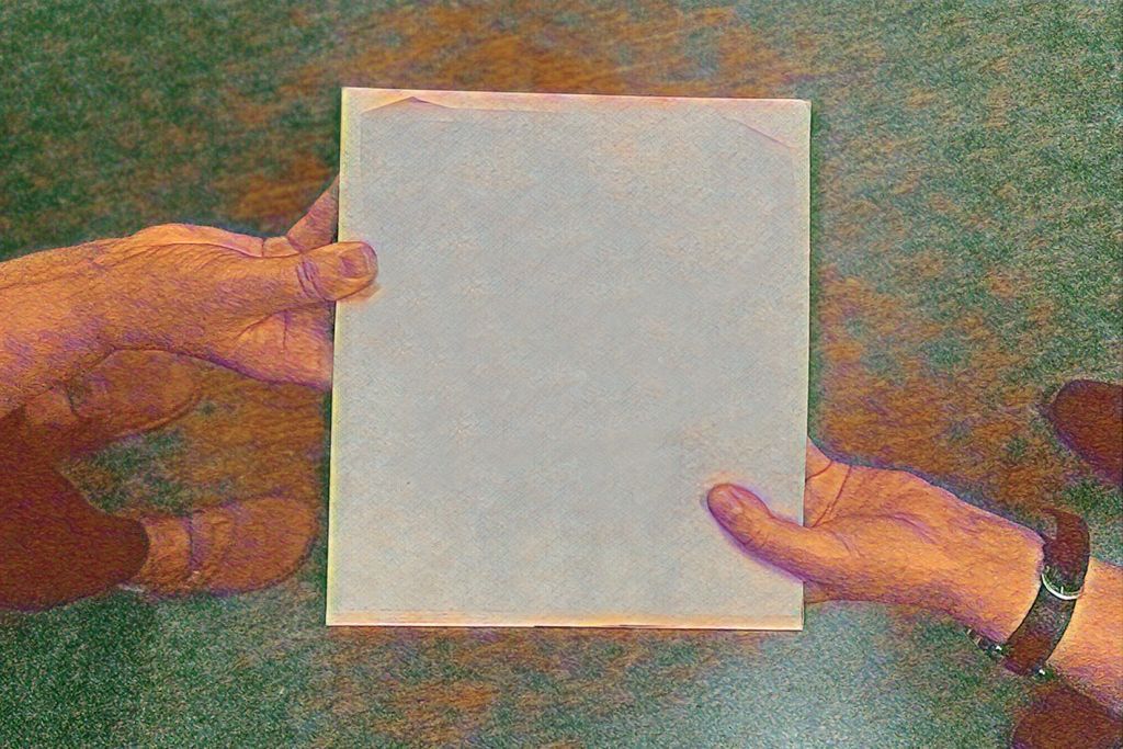 grafika | dwie ręce należące do różnych osób podają sobie książkę